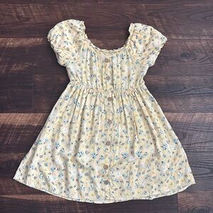 yellow dress with white and blue flowers